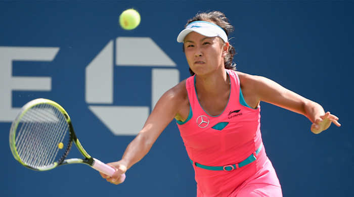 Sep 4, 2014; New York, NY, USA; Peng Shuai (CHN) returns a shot to Caroline Wozniacki (DEN) on day eleven of the 2014 U.S. Open tennis tournament at USTA Billie Jean King National Tennis Center.